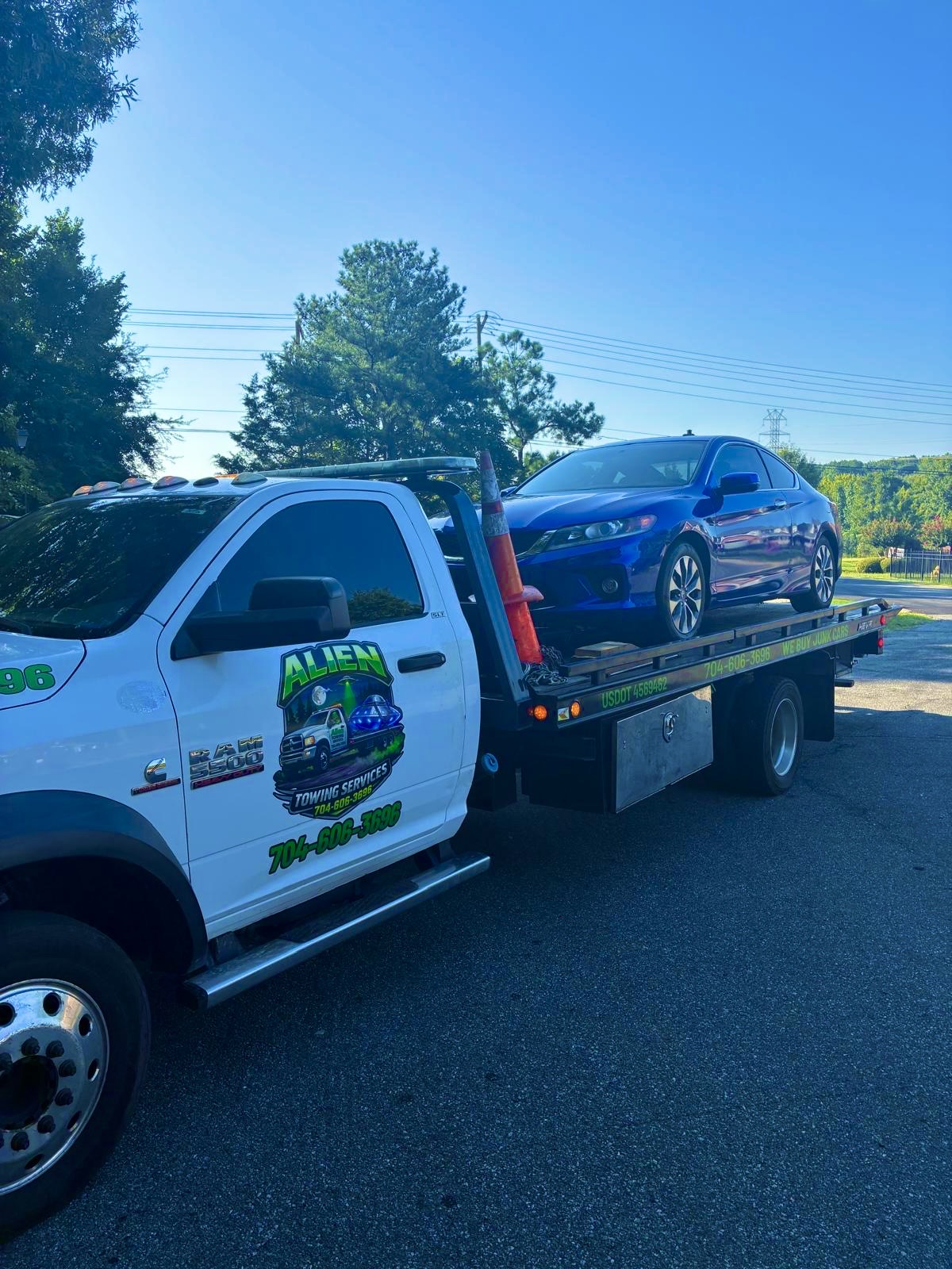 Tow truck with purple sedan
